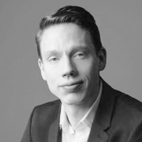 Headshot of Ben Van Handel, PhD a man with short hair in a suit jacket.