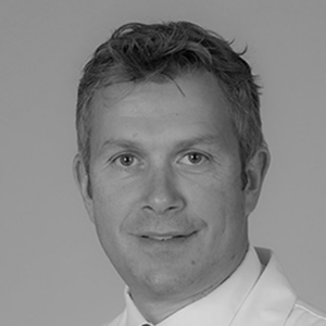 Headshot of Toby Maher, MD a man with short hair smiling.